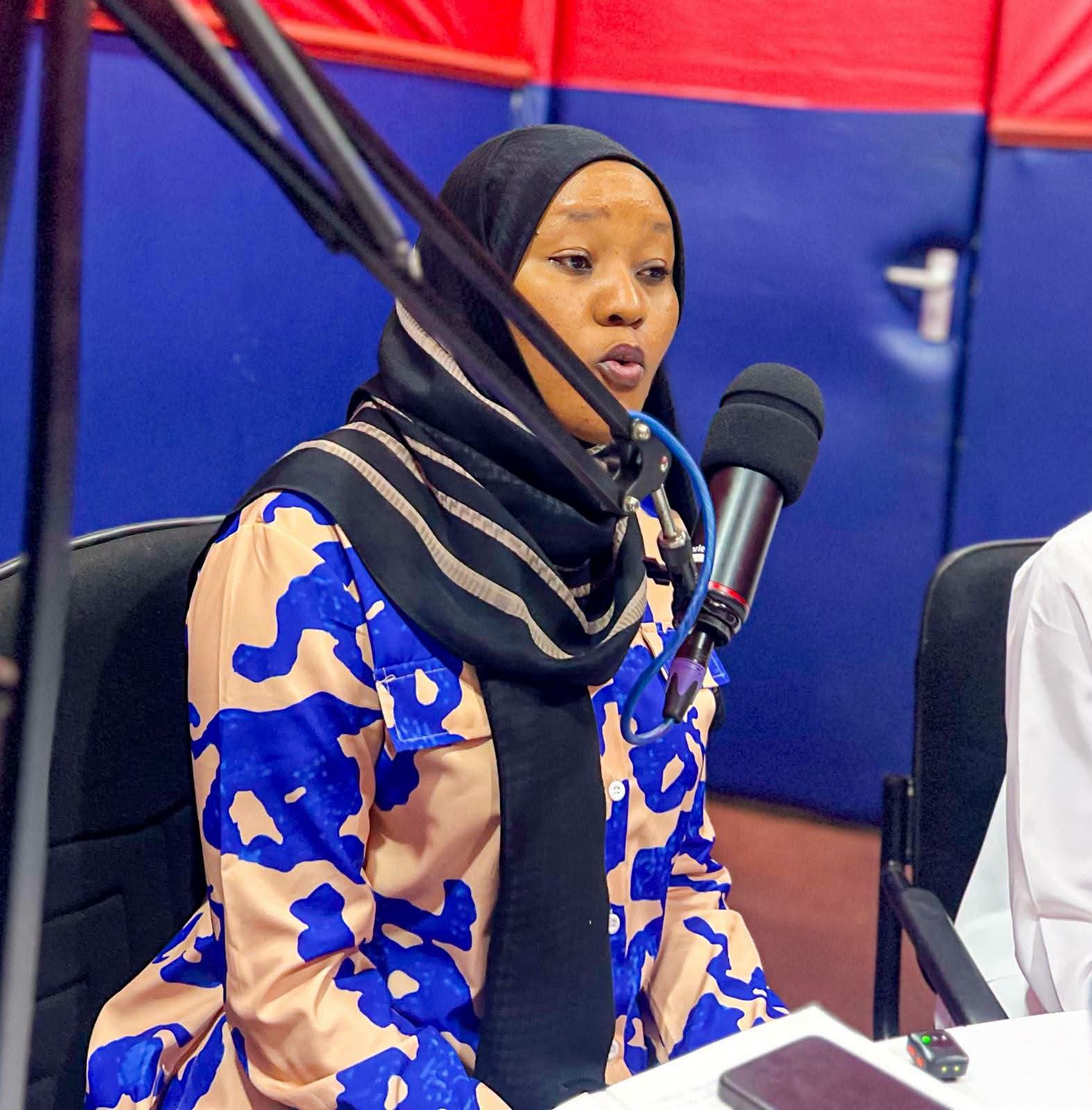 Guest speaking into the microphone during a JAC FM talk show