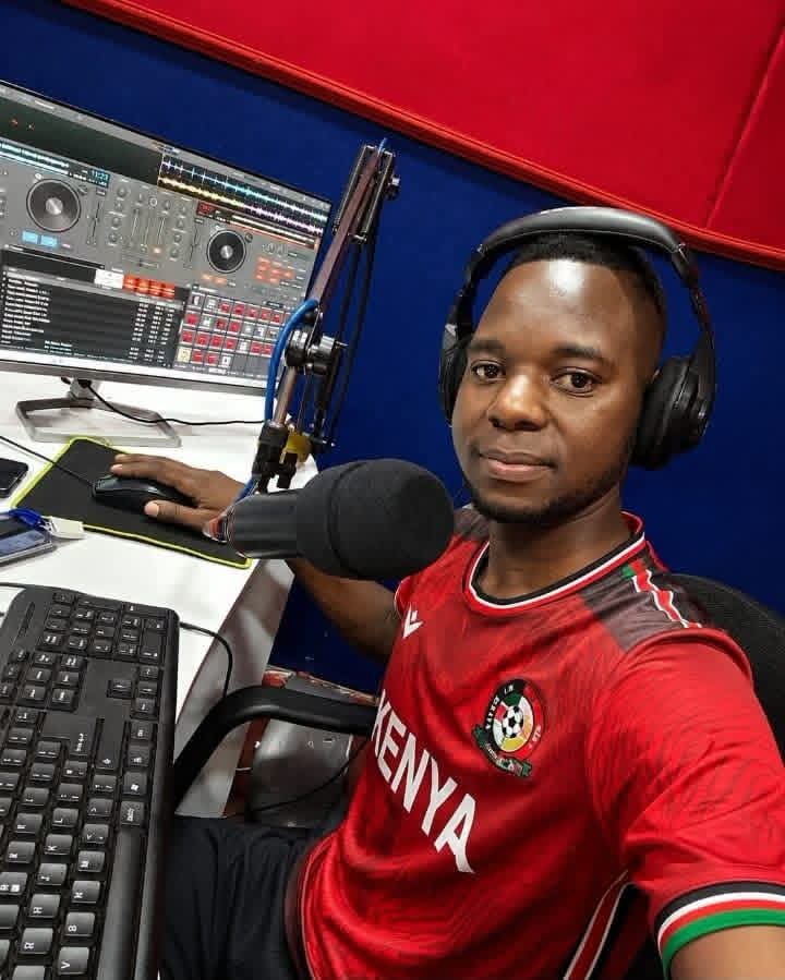 JAC FM presenter in a Kenya jersey at the broadcast desk