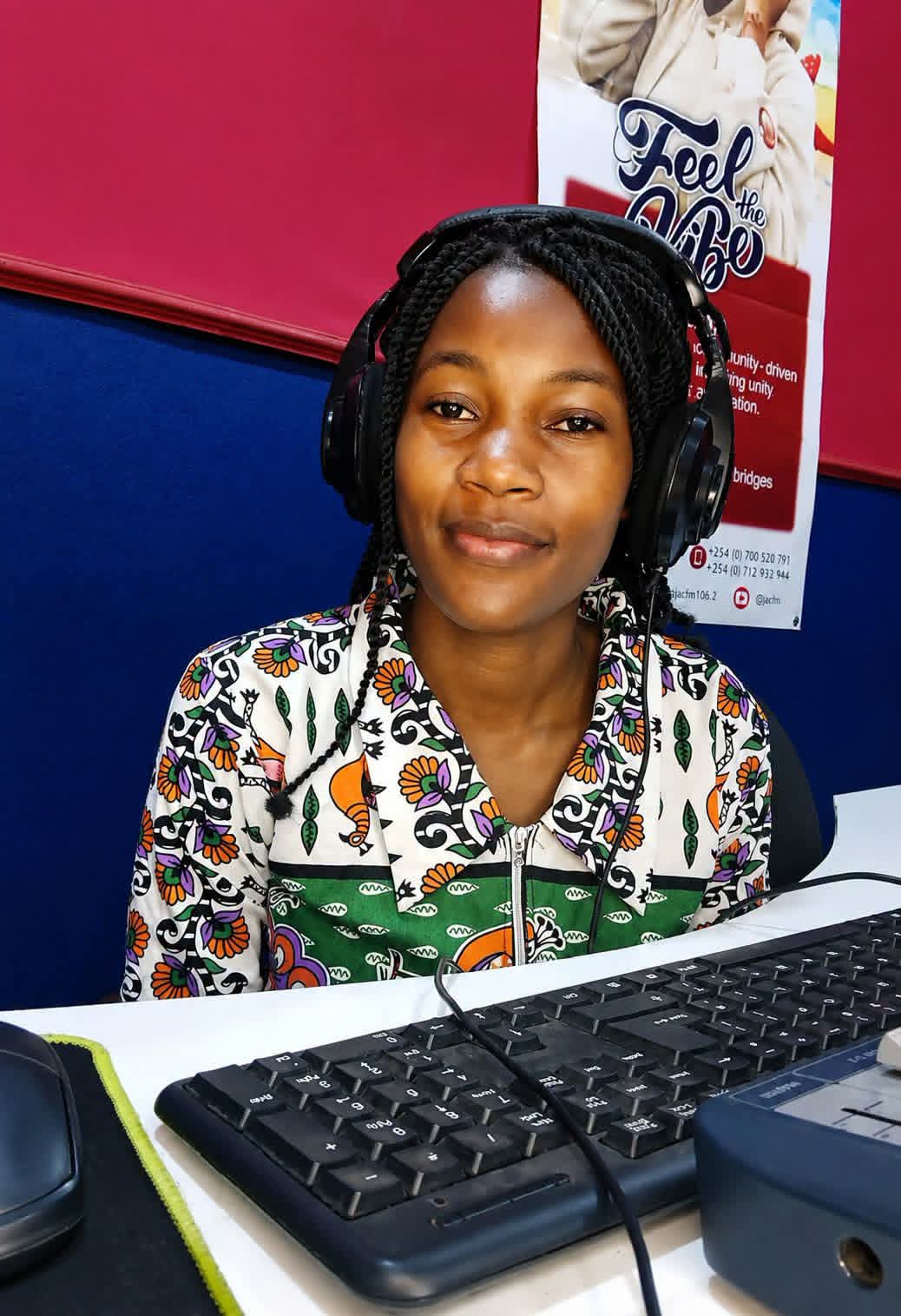 JAC FM presenter on headphones at the studio computer